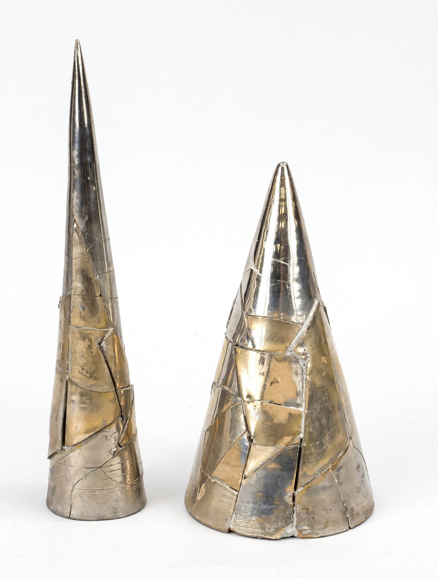 Pair of sculptures, pointed cone objects, clay covered with metal segments, signed and dated Roy