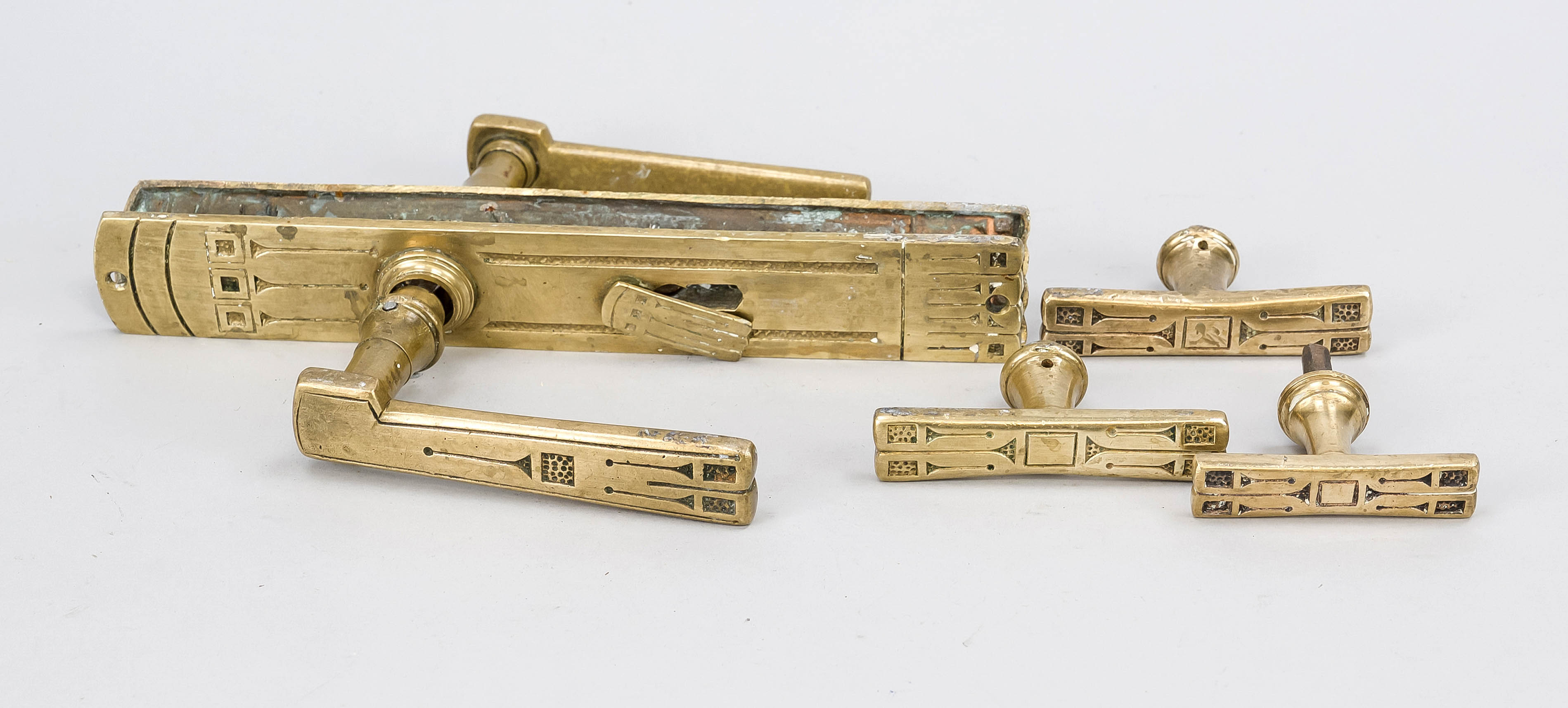 Lever handle set, early 20th century, brass. Passive cover with geometric ornament, profiled and