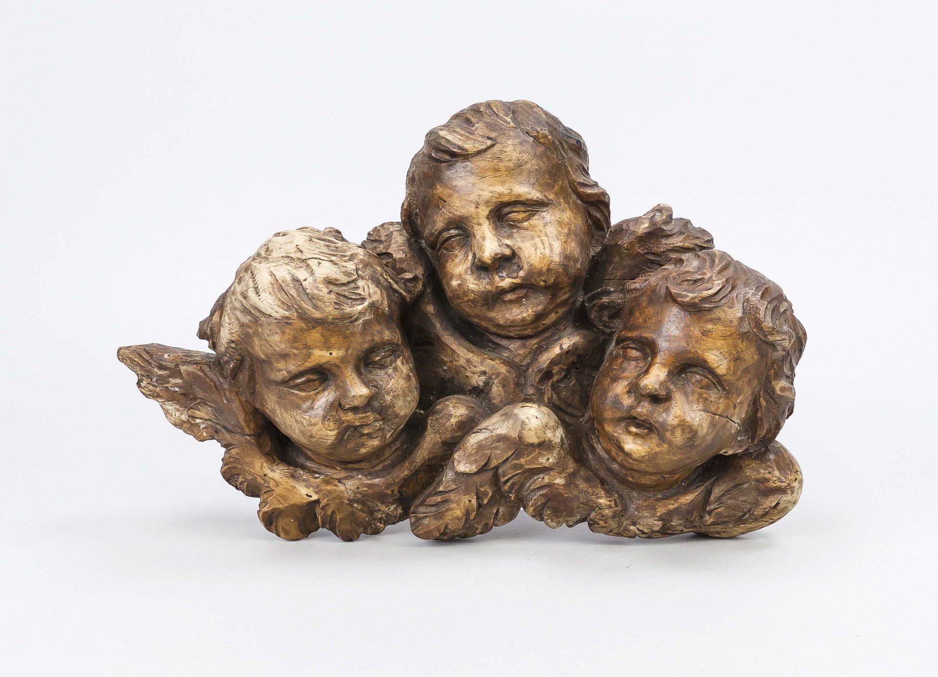 3 Putti Heads, 18th century, carved limewood, probably formerly part of a larger group, small iron
