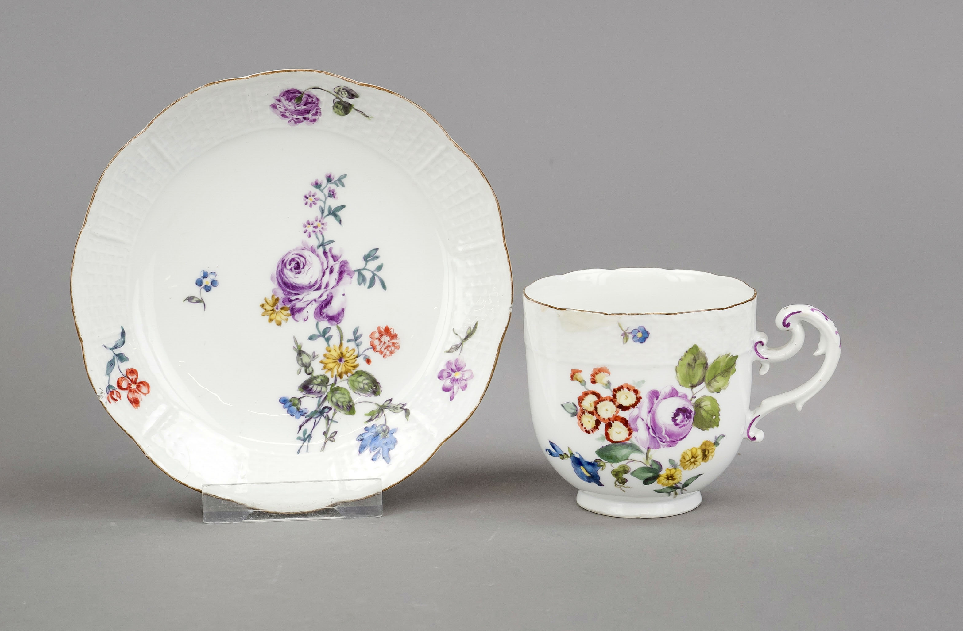 Cup and saucer, Meissen, 18th century, basket rim in relief, upturned volute handle, polychrome