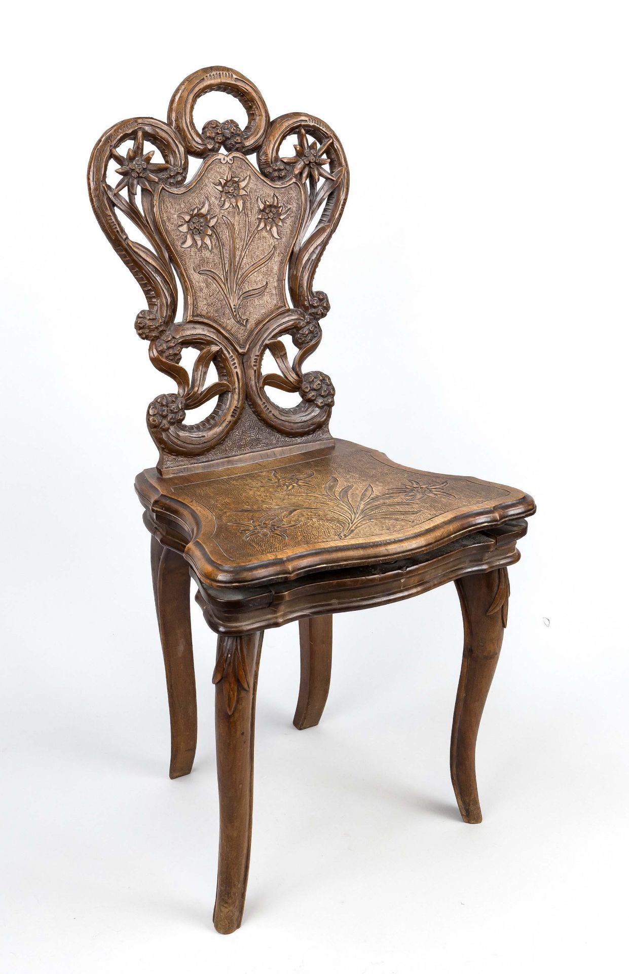 Children's chair with music box, around 1900, walnut. A music box built in under the seat, which