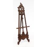 Staffellei, 20th century, mahogany. Open-worked and ornamentally carved. Height-adjustable picture