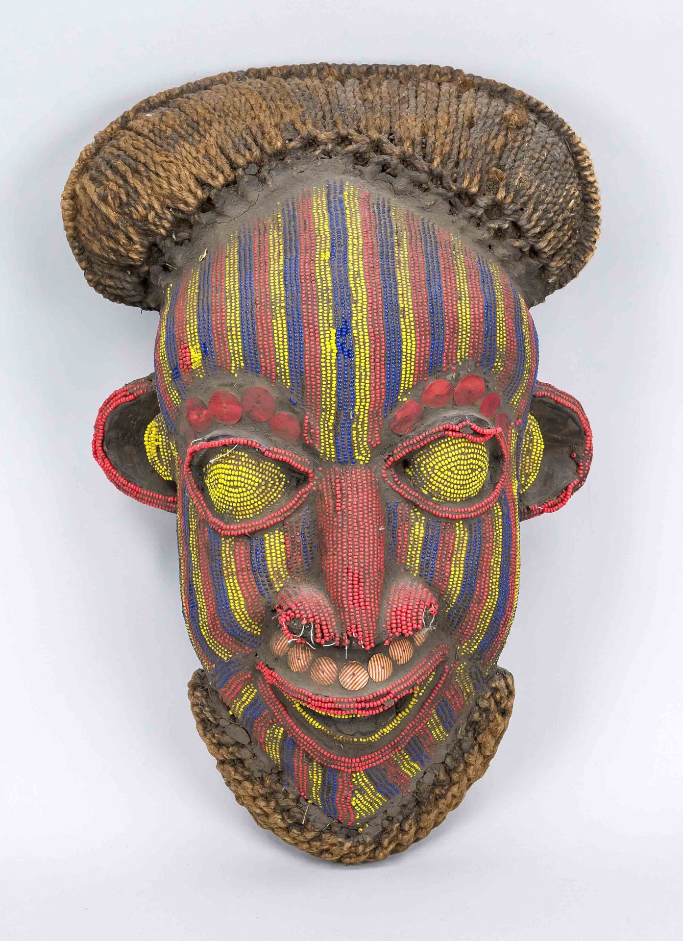 Mask, probably West African, probably 20th century, wood with textile and trimming with colorful