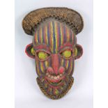 Mask, probably West African, probably 20th century, wood with textile and trimming with colorful