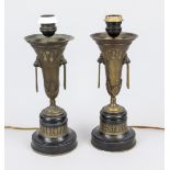 A pair of Historicist vase-shaped table lamps, circa 1900, on a round stand of black marble,