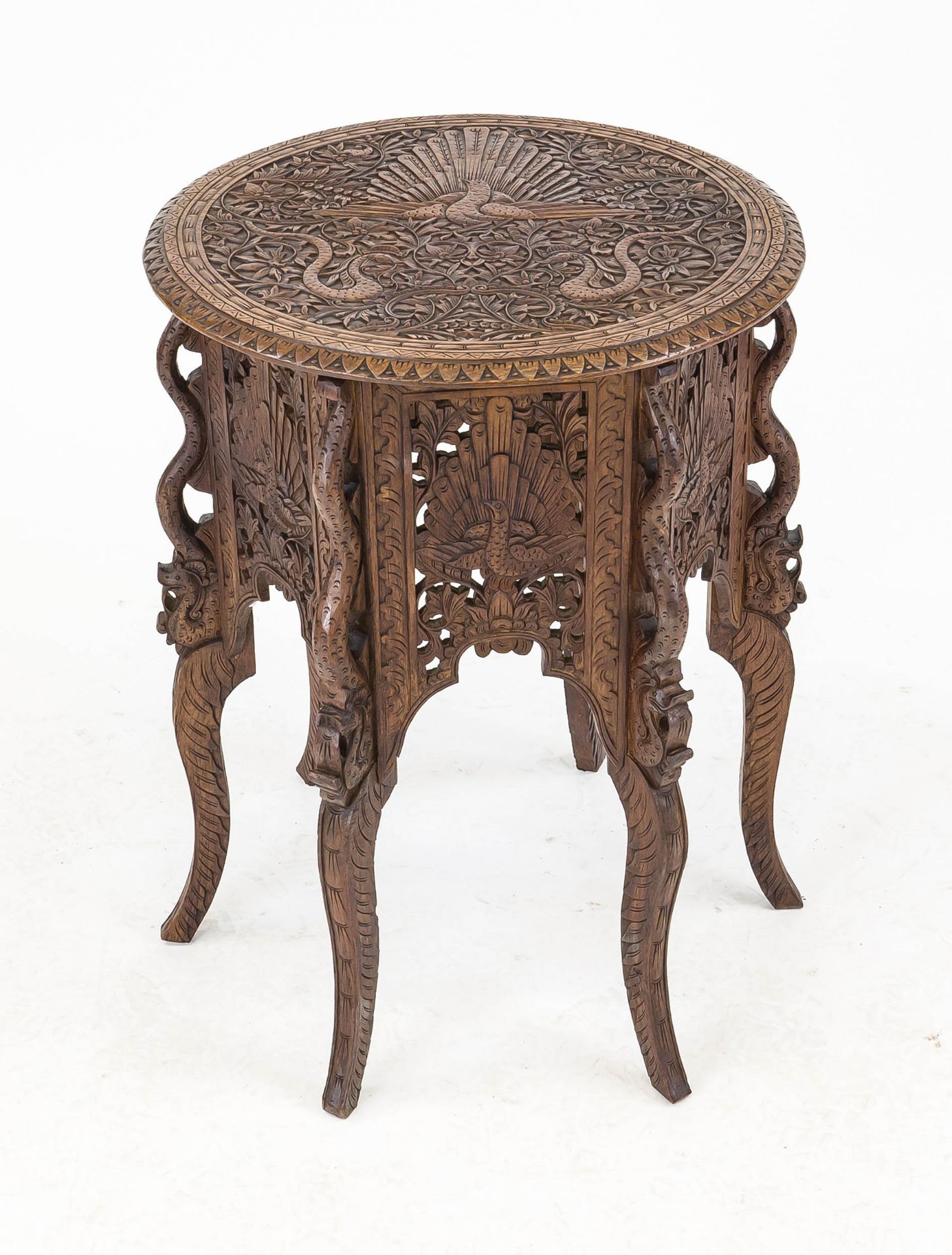 Side table, Southeast Asia, 20th century, dark hardwood. Round, elaborately carved top on a