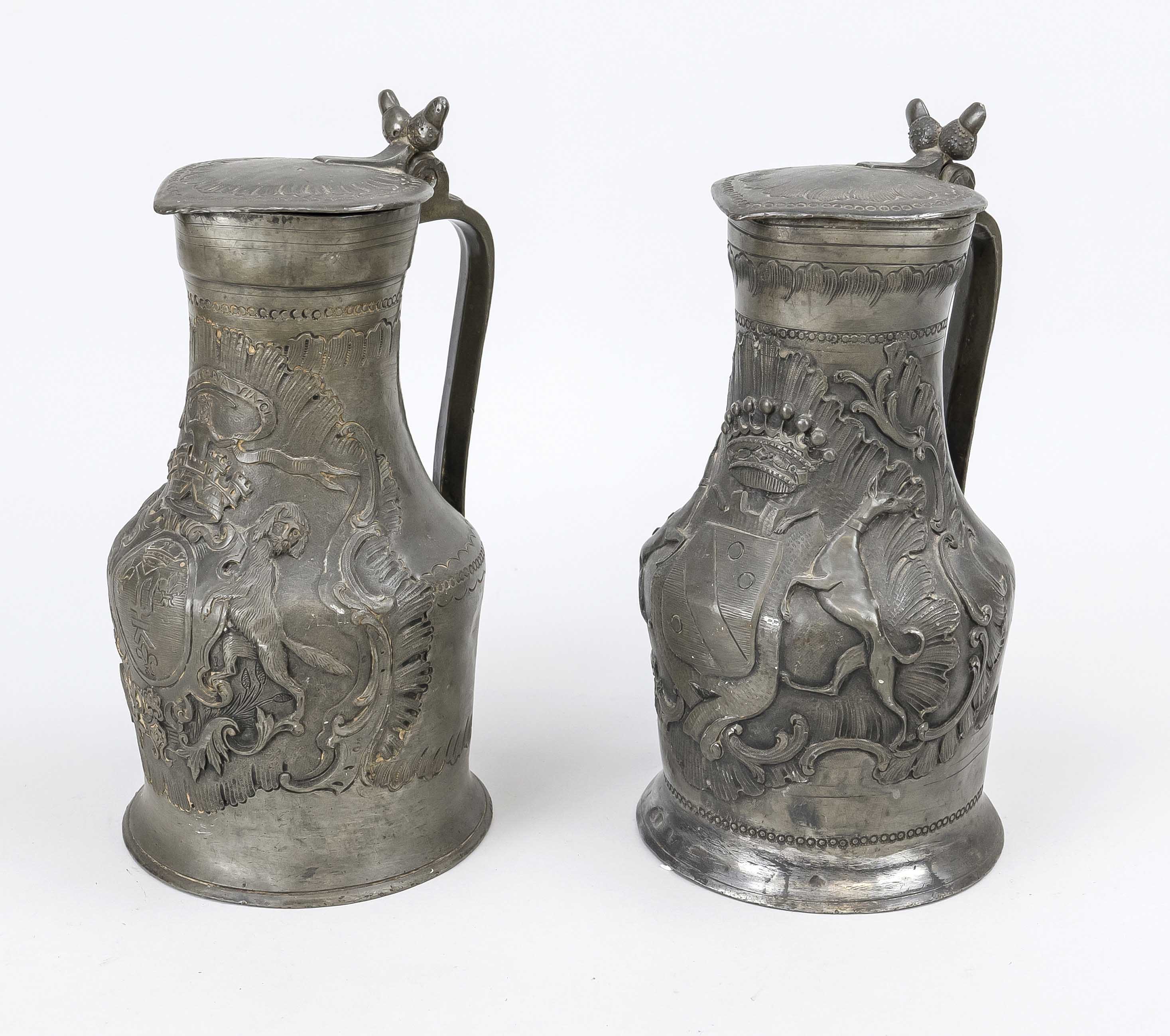 2 pewter jugs, 18th century Bellied body with hinged lid with acorn finial. Relief decoration with