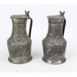 2 pewter jugs, 18th century Bellied body with hinged lid with acorn finial. Relief decoration with