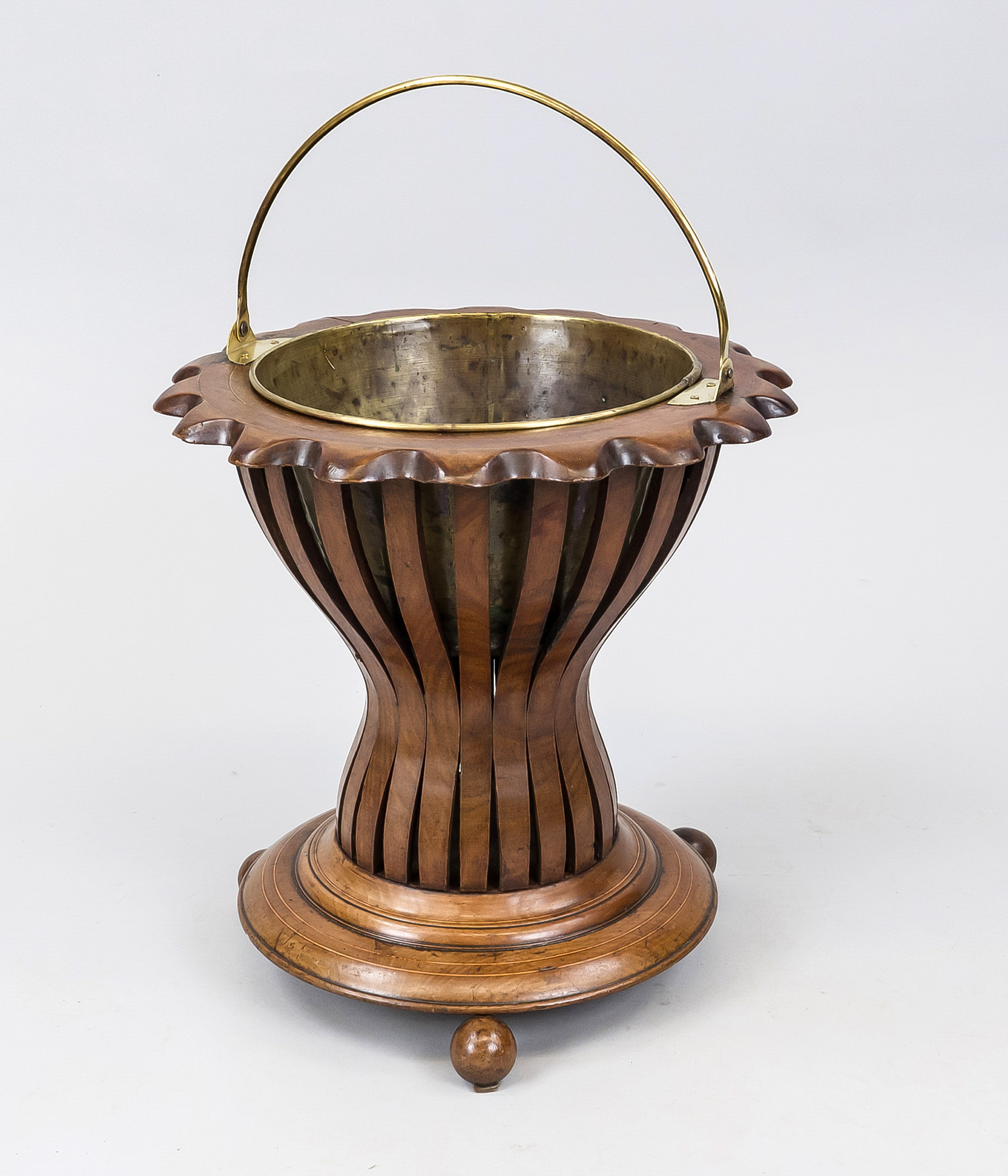 Teestoof, Holland 19th century, mahogany basket with slightly curved walls on 3 ball feet, brass