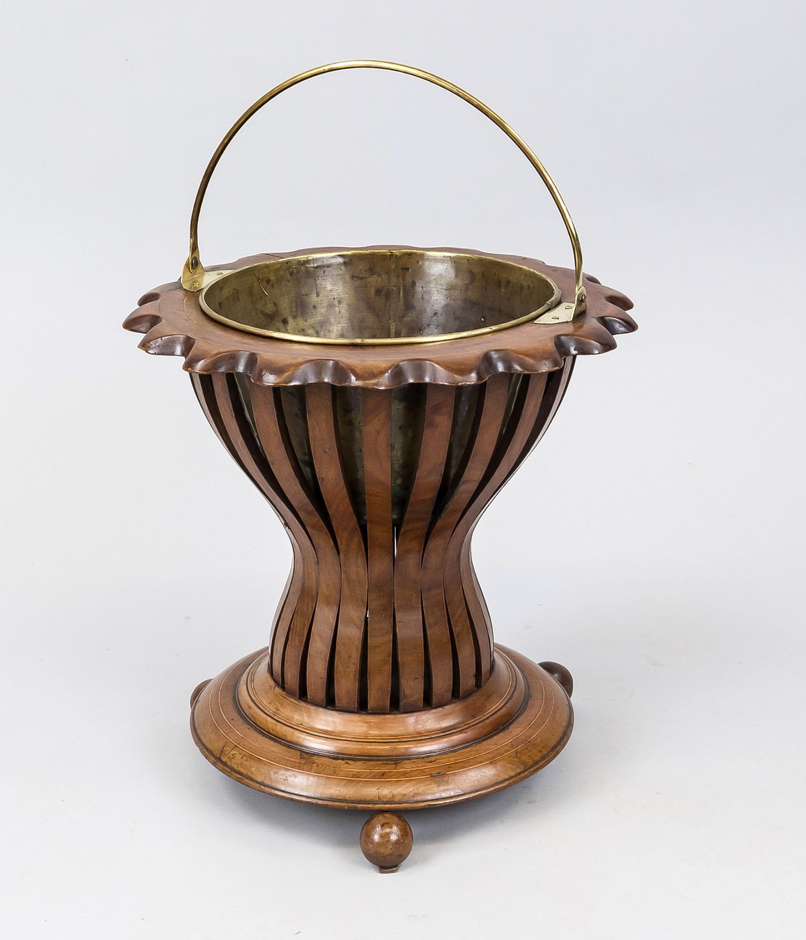 Teestoof, Holland 19th century, mahogany basket with slightly curved walls on 3 ball feet, brass