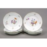 Eight dinner plates, 20th century, curved form with ogee rim, polychrome floral decoration, gold