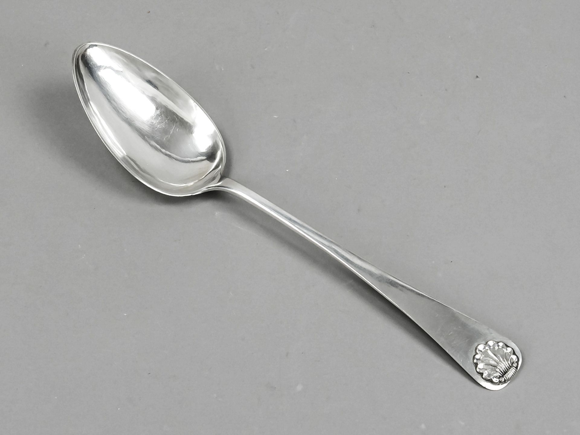 A serving spoon, probably German, mid-19th century, Heiligenhafen (?), maker's mark IVM, inscribed