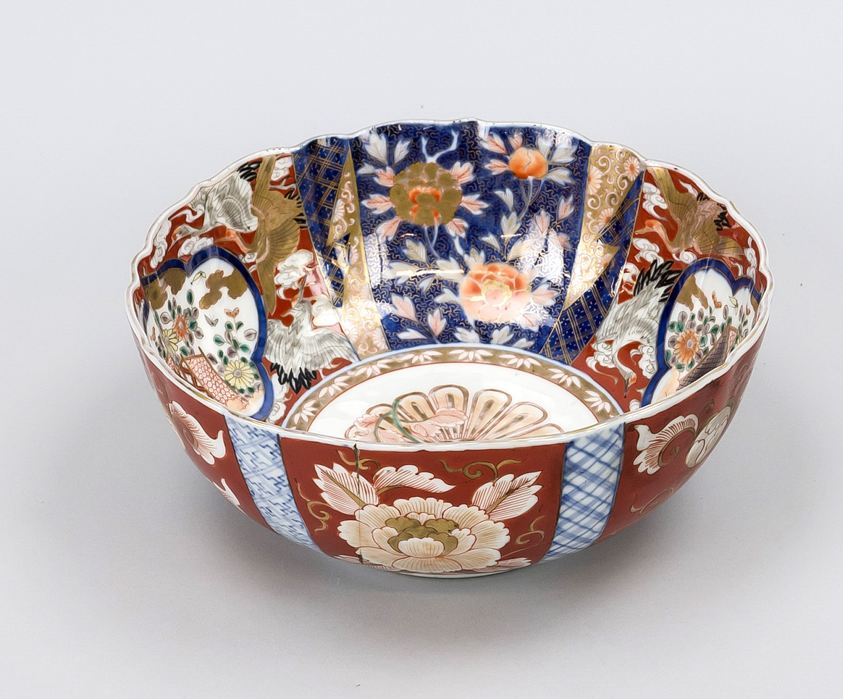 Glazed Imari bowl, Japan, 20th century. Inner and outer walls under and on the glaze in cobalt blue,