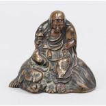 Small figure of a saint, probably China, probably 19th century, bronze. Sitting on an animal with