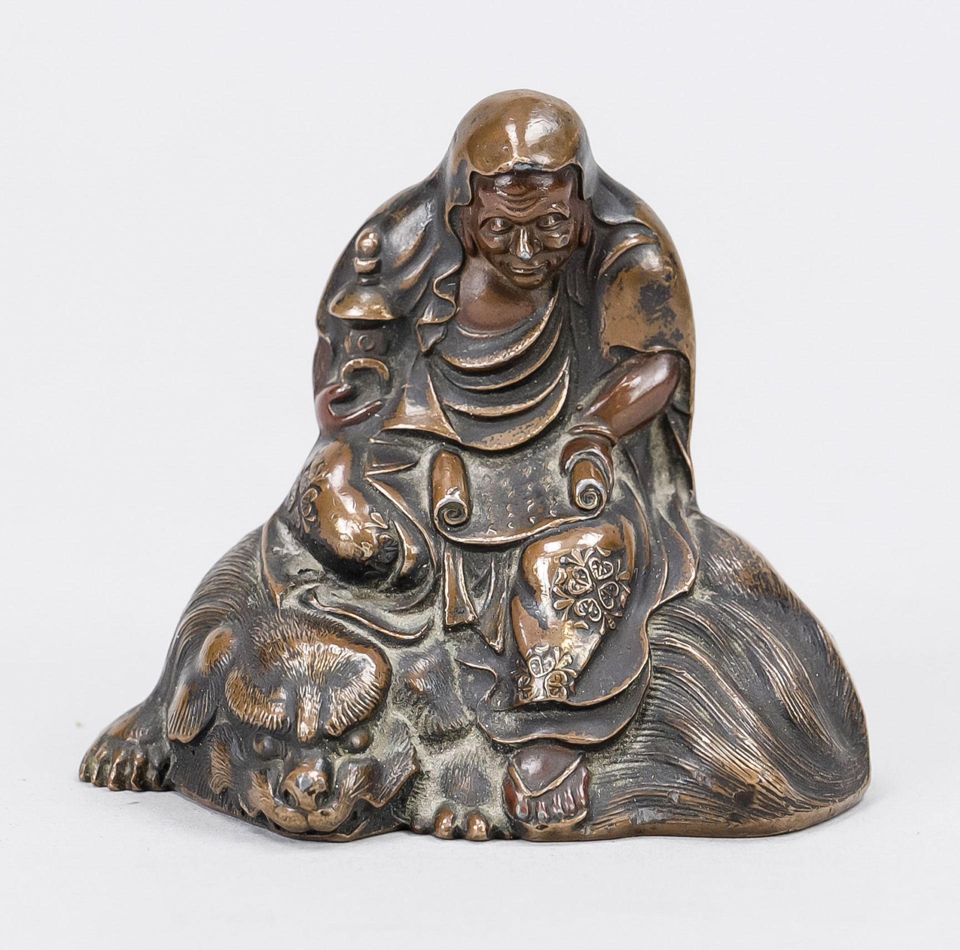 Small figure of a saint, probably China, probably 19th century, bronze. Sitting on an animal with