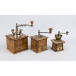 Three old coffee grinders, c. 1900, metal and wood, one in walnut with thread inlays, h. to 27 cm