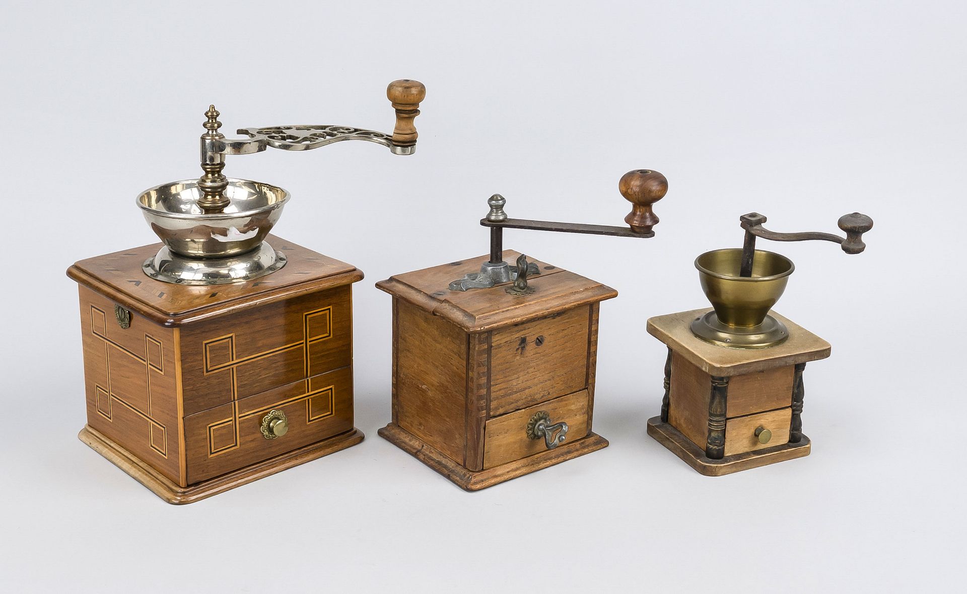 Three old coffee grinders, c. 1900, metal and wood, one in walnut with thread inlays, h. to 27 cm