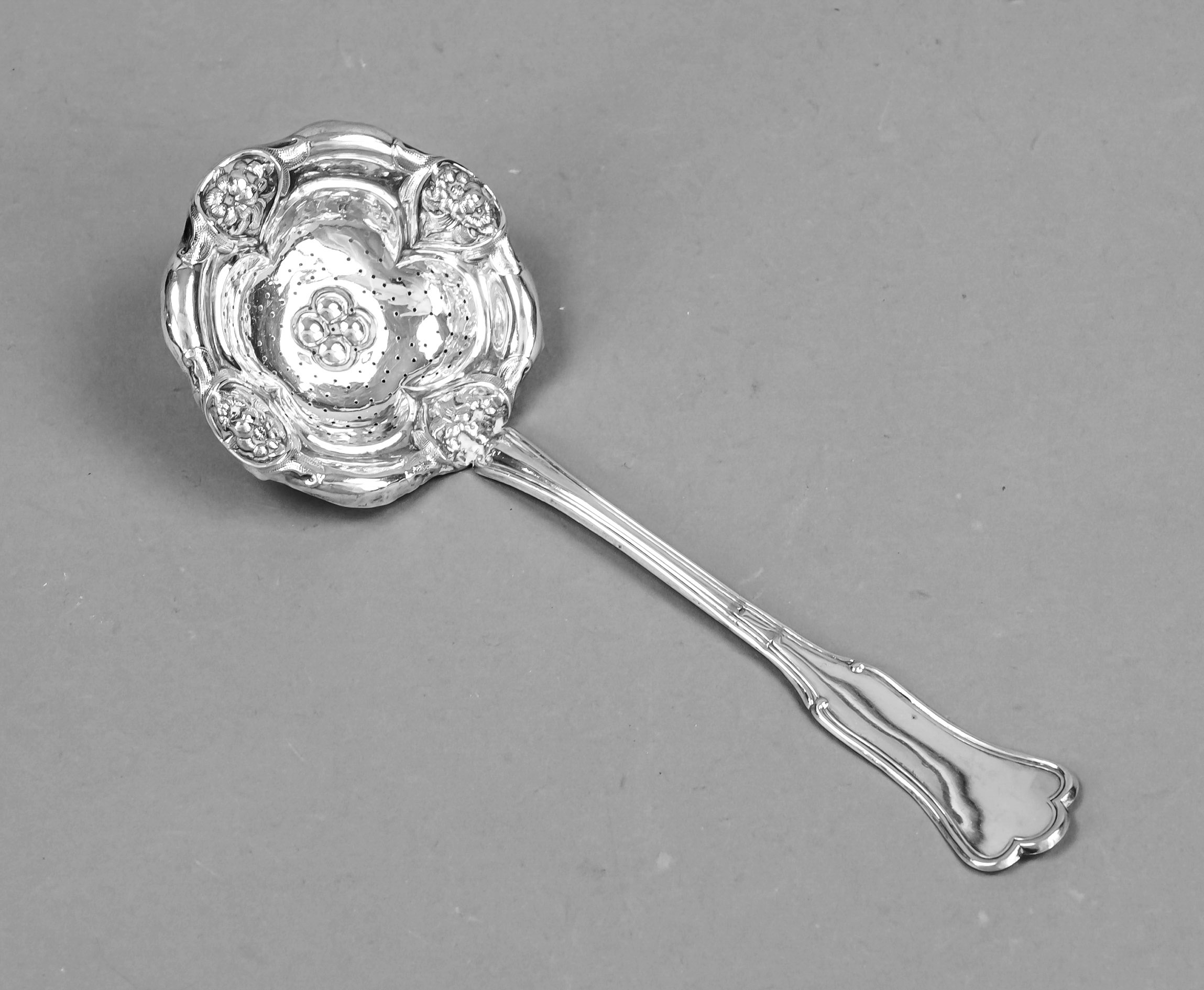 Tea strainer with handle, late 19th century, probably under-alloyed silver, flower form, floral