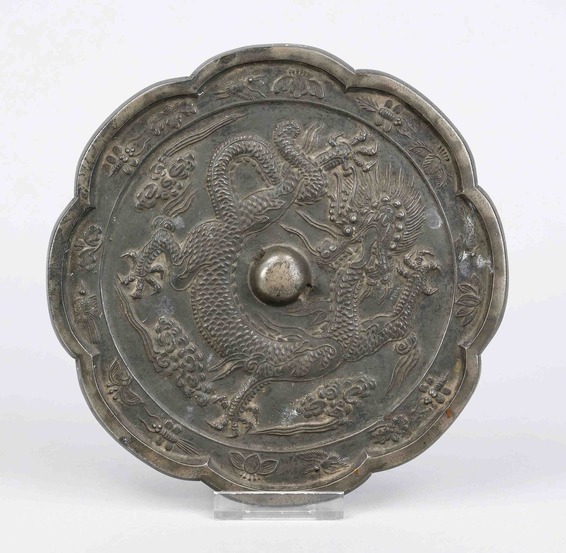 Bronze mirror, China, exact age uncertain. Eight-pass curved, relief decoration with a writhing
