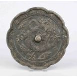 Bronze mirror, China, exact age uncertain. Eight-pass curved, relief decoration with a writhing