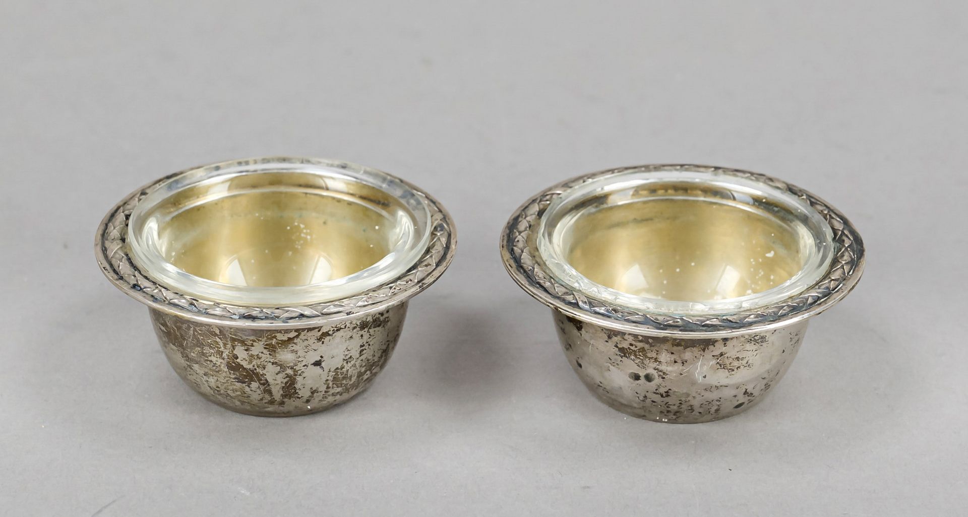 Pair of round saliers, German, 20th century, silver 800/000, gilded interior, smooth form, relief