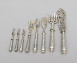 Eight serving pieces, 20th century, silver tested, each with round filled handle with relief