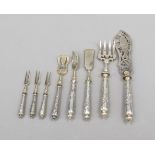 Eight serving pieces, 20th century, silver tested, each with round filled handle with relief