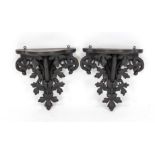Pair of wall brackets, 20th century, solid, dark-stained wood, curved base, openwork carved with
