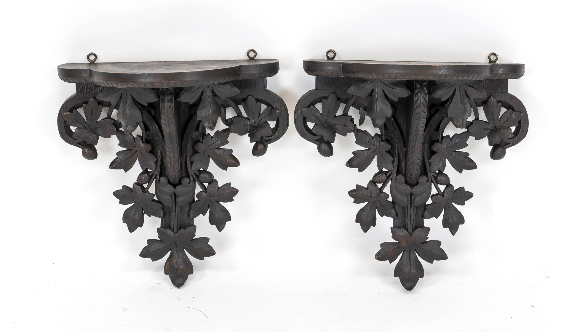 Pair of wall brackets, 20th century, solid, dark-stained wood, curved base, openwork carved with