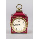 Swiza travel alarm clock, circa 1985, red plastic with gilded decorative elements, top handle,