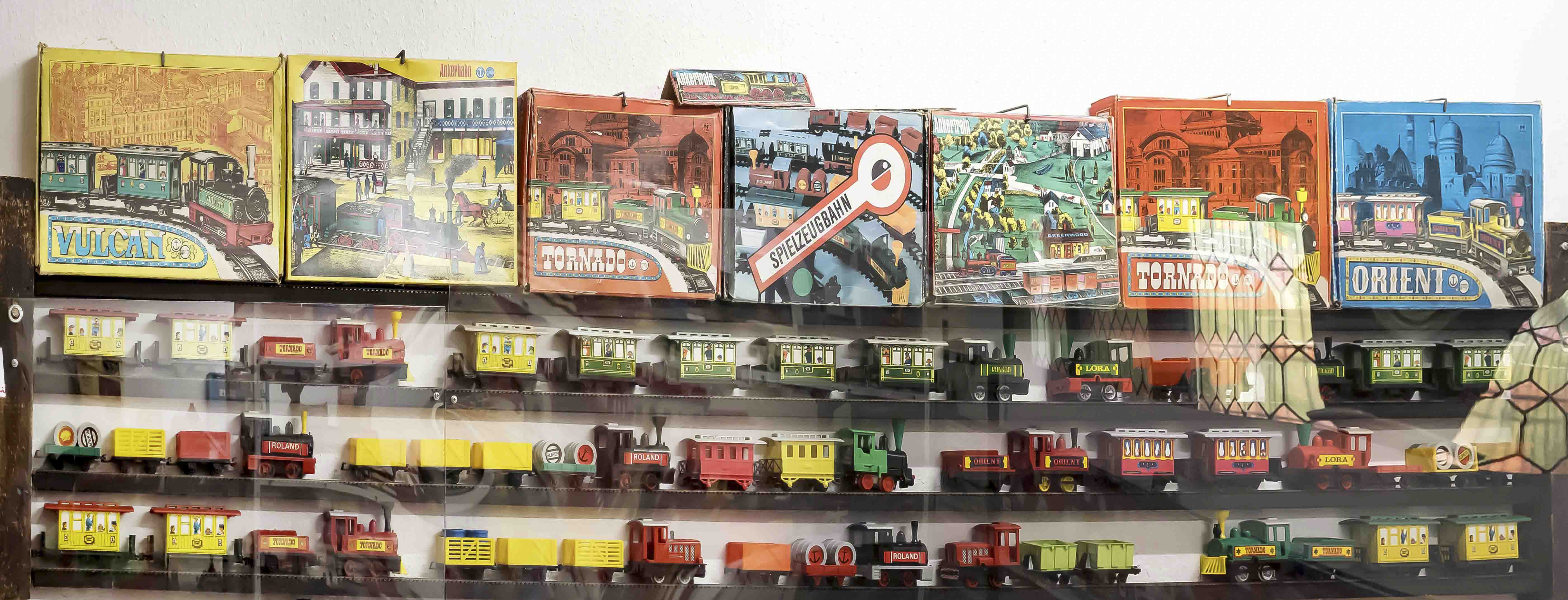 Two showcases with GDR toys, Ankerbahn various models of wagons and locomotives, spring mechanism/