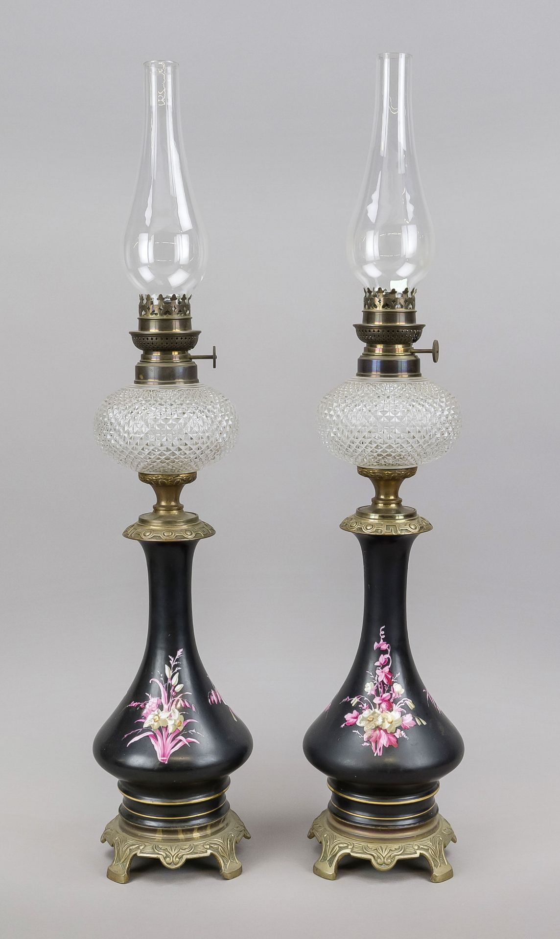 Pair of kerosene lamps, late 19th/early 20th century, vases with flowers on a black ground with