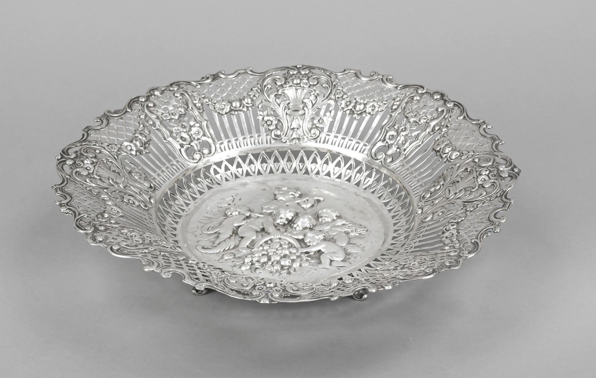 Round openwork bowl, German, 20th century, silver 800/000, on 4 feet, curved rim, wide rim richly