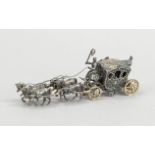 A four-horse miniature carriage, German, 20th century, silver 800/000, with staffage, l. 13 cm,