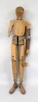 Life-size jointed doll, probably Germany around 1900, solid, made of various woods and iron cuffs.