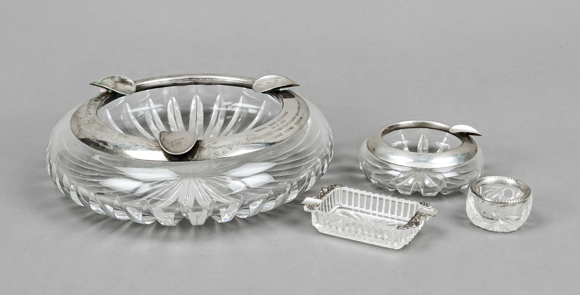Mixed lot of four pieces, 20th century, 3 ashtrays and saliere, each clear glass with silver rim