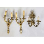 A pair and a single wall lamp, 19th/20th century, bronze/brass. All with candle holders, rubbed,
