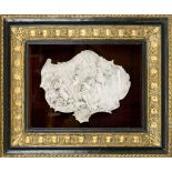 Stone carving, exact age unknown. Curved, multi-figure scene. Behind glass in an ornamented and