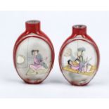2 erotic snuffbottles, China Republic period. Reverse glass painting and red overlaid glass. Spoon