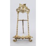 Table easel, late 19th century, gilt cast metal. Open-worked and ornamented, top with birds, rubbed,