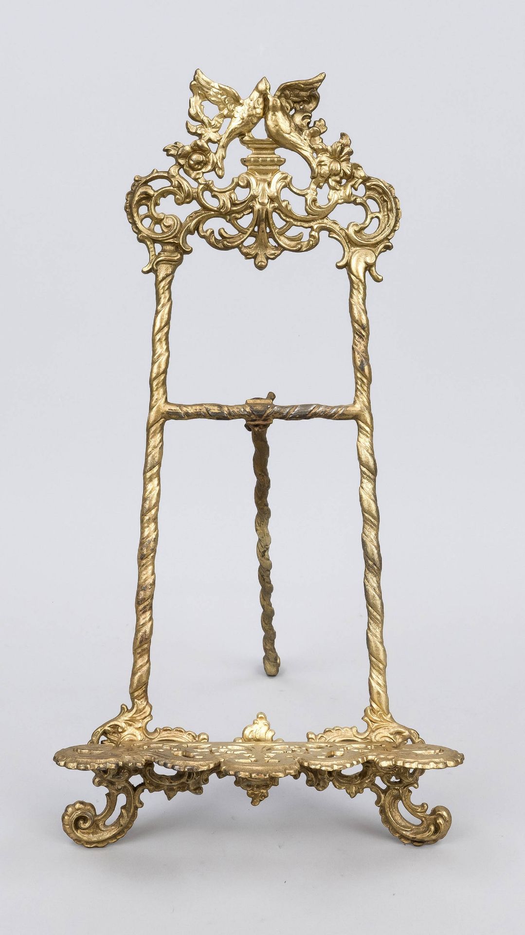 Table easel, late 19th century, gilt cast metal. Open-worked and ornamented, top with birds, rubbed,