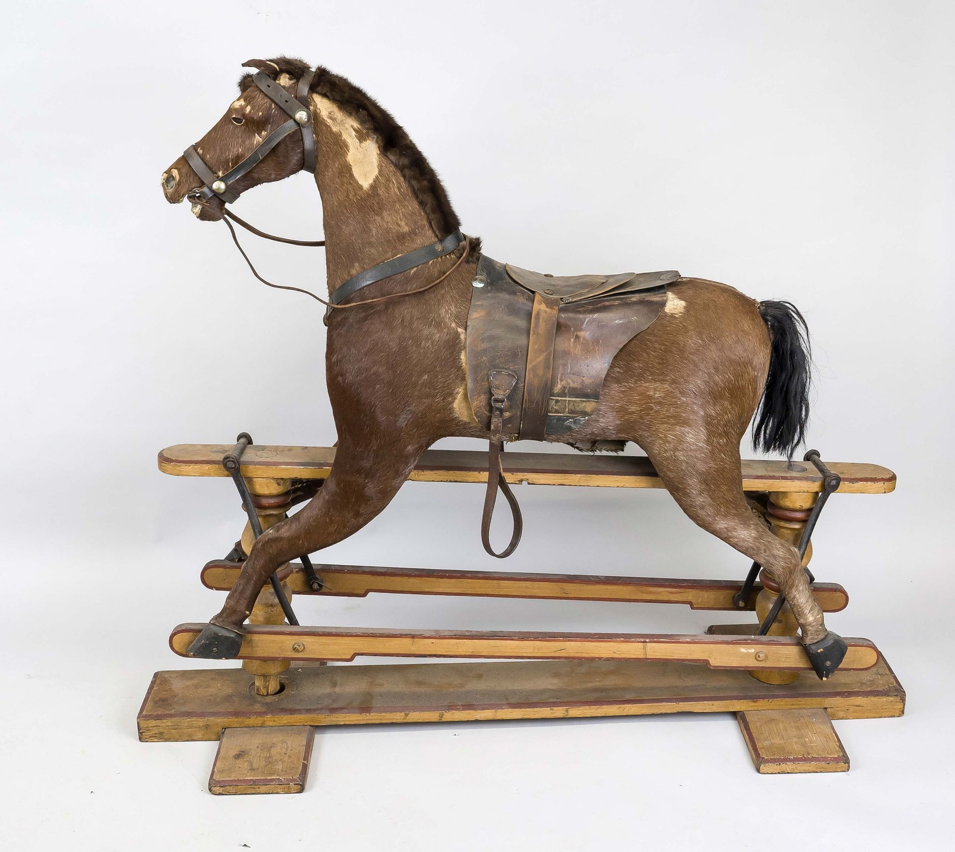 Rocking horse, late 19th century, with real fur (probably foal), leather saddle and bridle.