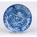 Dragon plate, China. Deep hollowed plate with cobalt blue dragon decoration in mirror, on the rim
