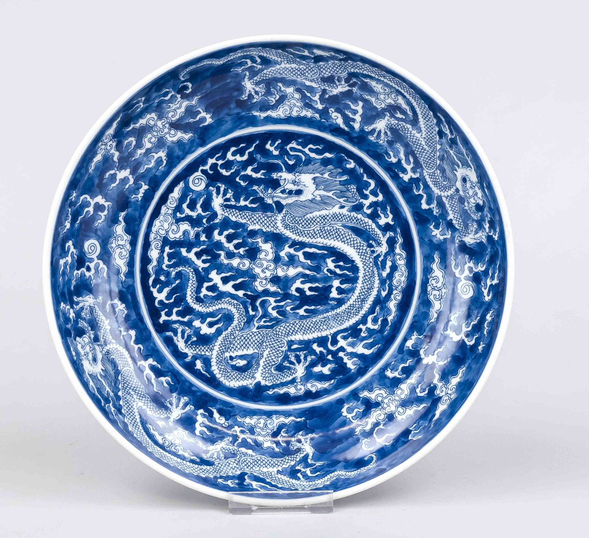 Dragon plate, China. Deep hollowed plate with cobalt blue dragon decoration in mirror, on the rim