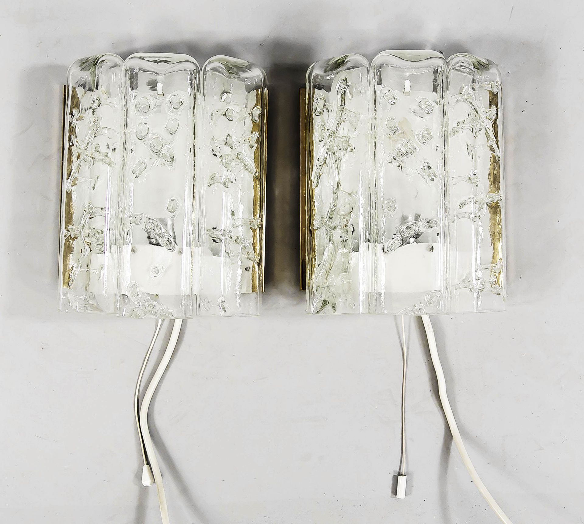 Pair of wall lamps, 1970s, fused clear glass, one socket each, h.22, w. 18 cm