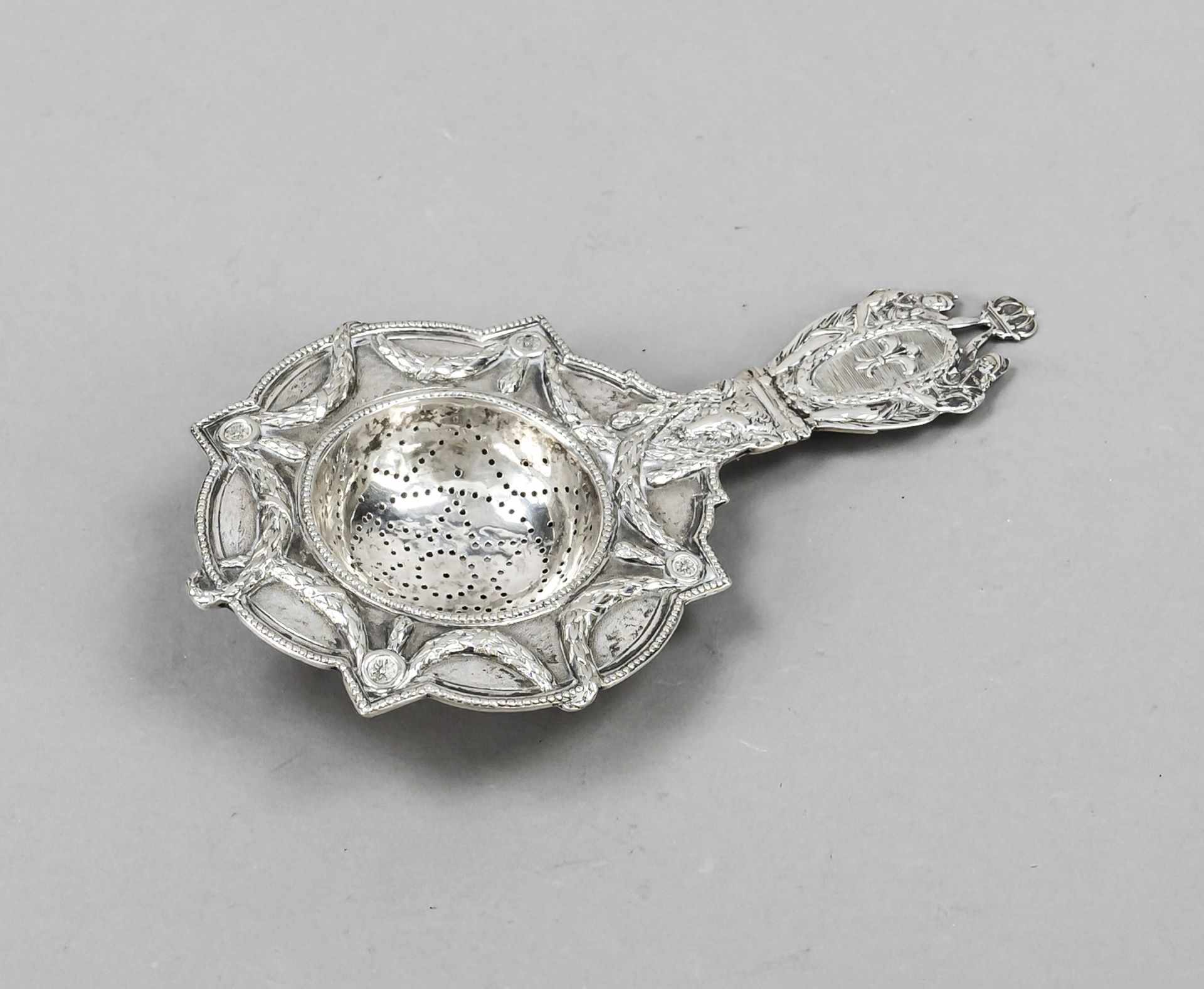 Tea strainer, c. 1900, silver tested, wall with rich relief decoration, floral and figural motifs,
