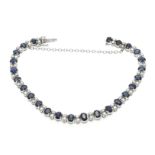 Sapphire and diamond bracelet WG 750/000 with SI chain WG 585/000 set with 25 oval faceted sapphires