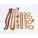 A bag full of amber necklaces and bracelets, 20th century, various qualities