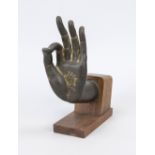Buddha hand, exact origin and age uncertain. Bronze on a dark hardwood stand, slightly rubbed, h. 23