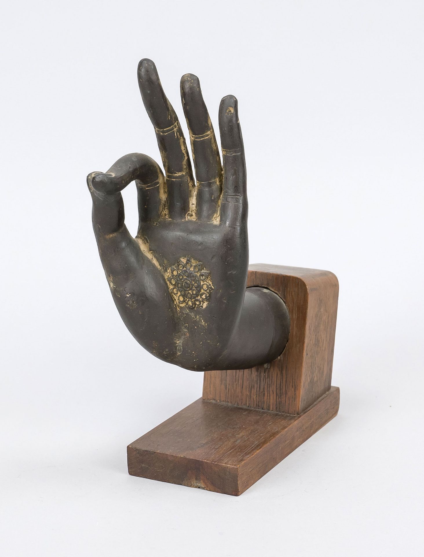 Buddha hand, exact origin and age uncertain. Bronze on a dark hardwood stand, slightly rubbed, h. 23